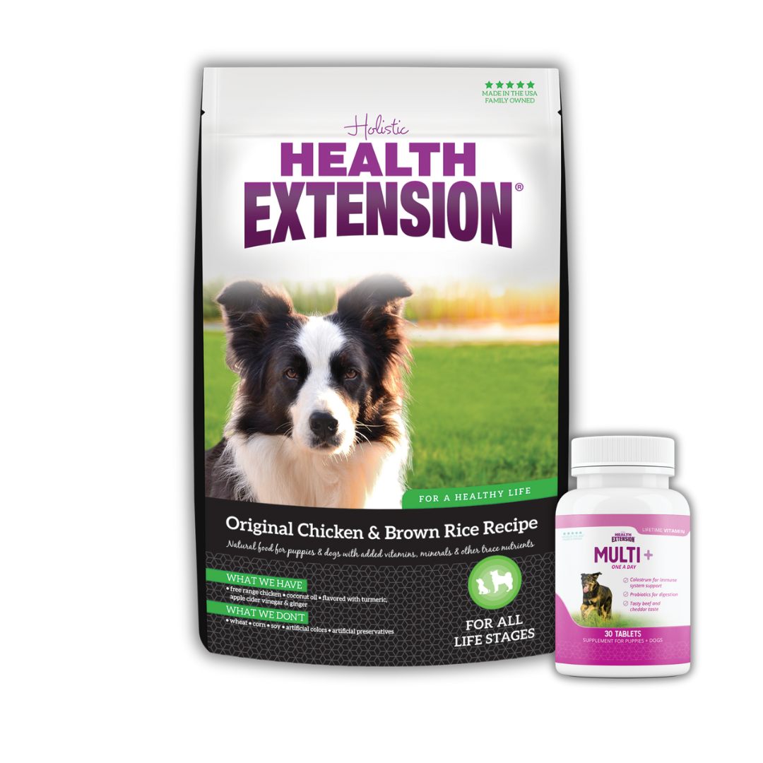 A bag of Health Extension Original Chicken & Brown Rice Recipe dog food paired with a bottle of Multi+ vitamins for dogs. The packaging features an image of a black and white dog on a vibrant green field.