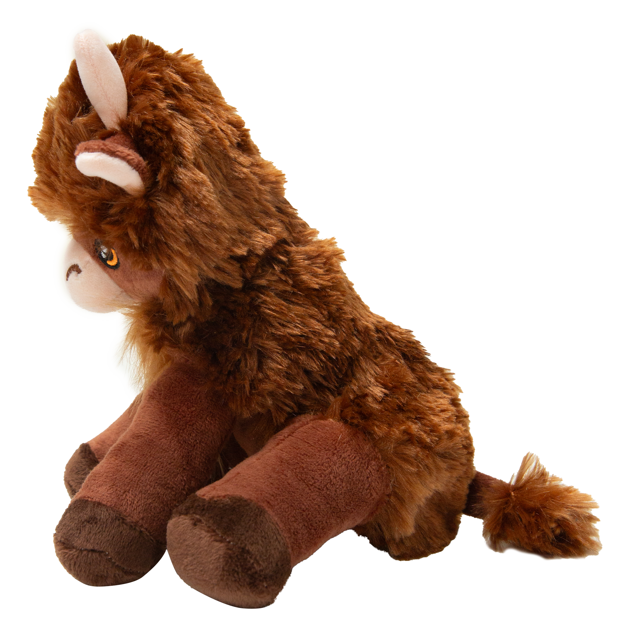 Nyland the Highland by Snugarooz is a plush dog toy featuring soft brown fur, round eyes, small white horns, and a fluffy mane, sitting upright against a white background.