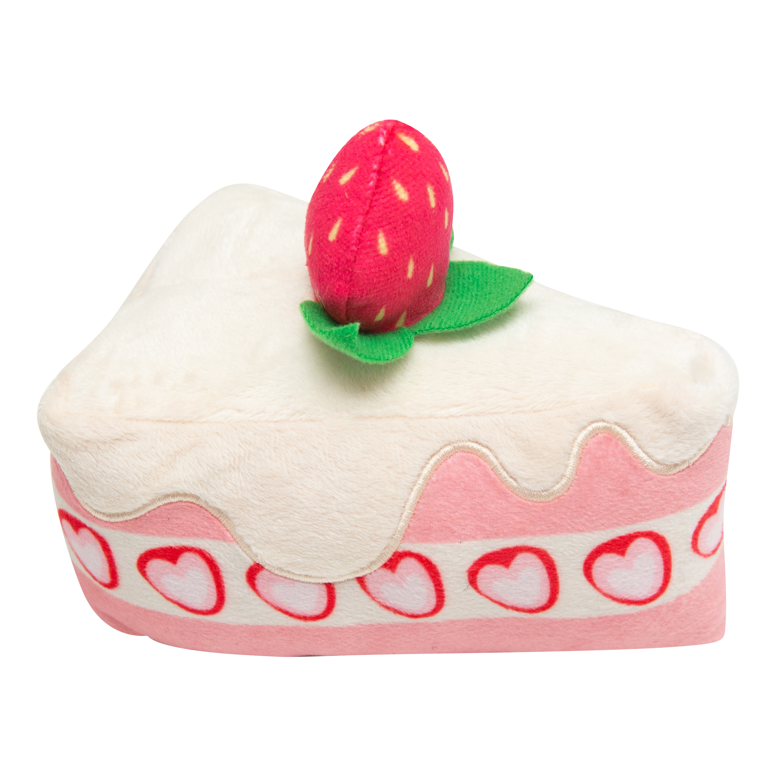 The Snugarooz Piece of Cake is a plush dog toy shaped like a cake slice with white icing, pink layers, heart decorations, and a strawberry on top—a delightful treat for your furry friend.