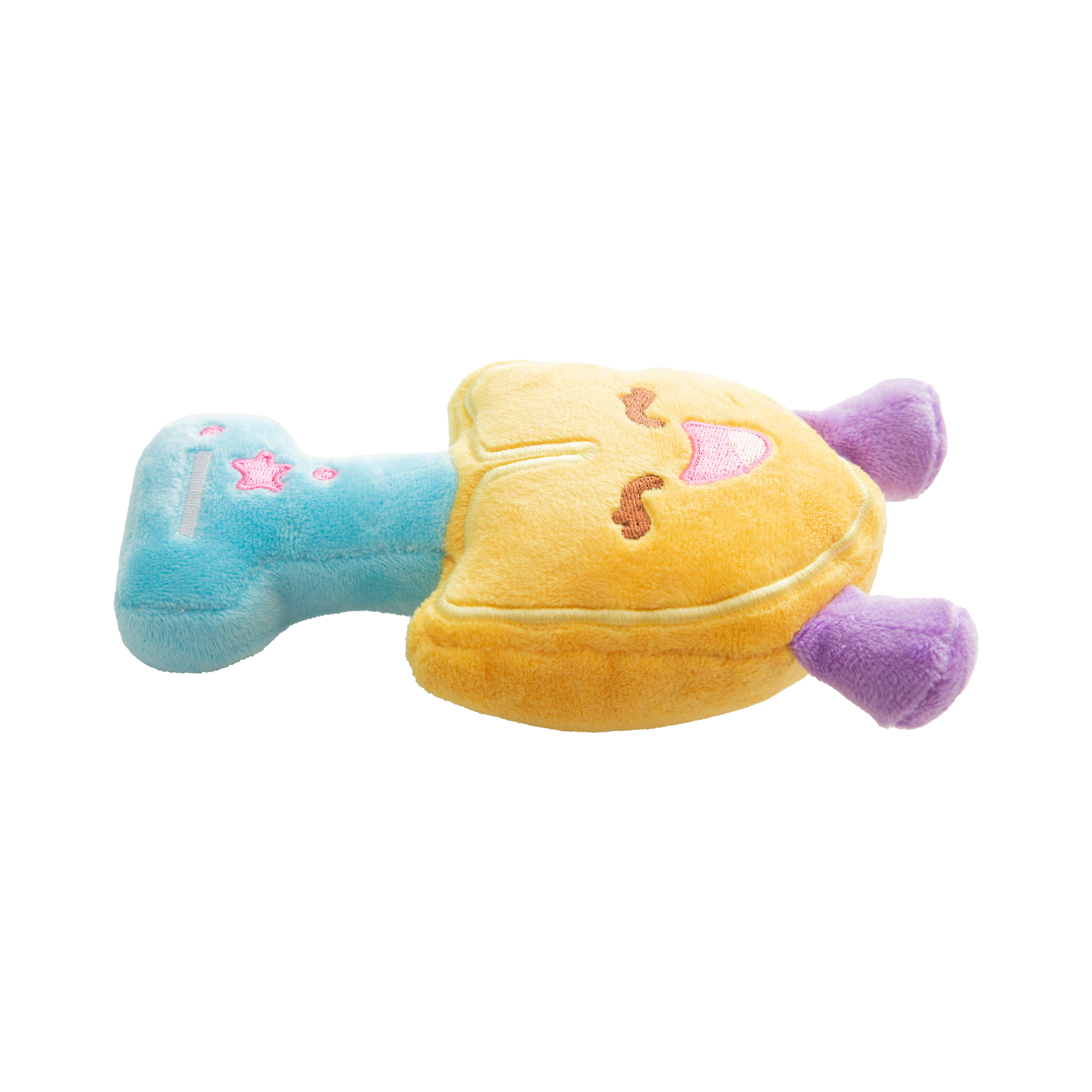 The Snugarooz Scoop There It Is is a plush dog toy shaped like a smiling yellow shield with embroidered details, purple legs, a blue top with pink stars and dashes, made from recycled water bottles—great for interactive play.