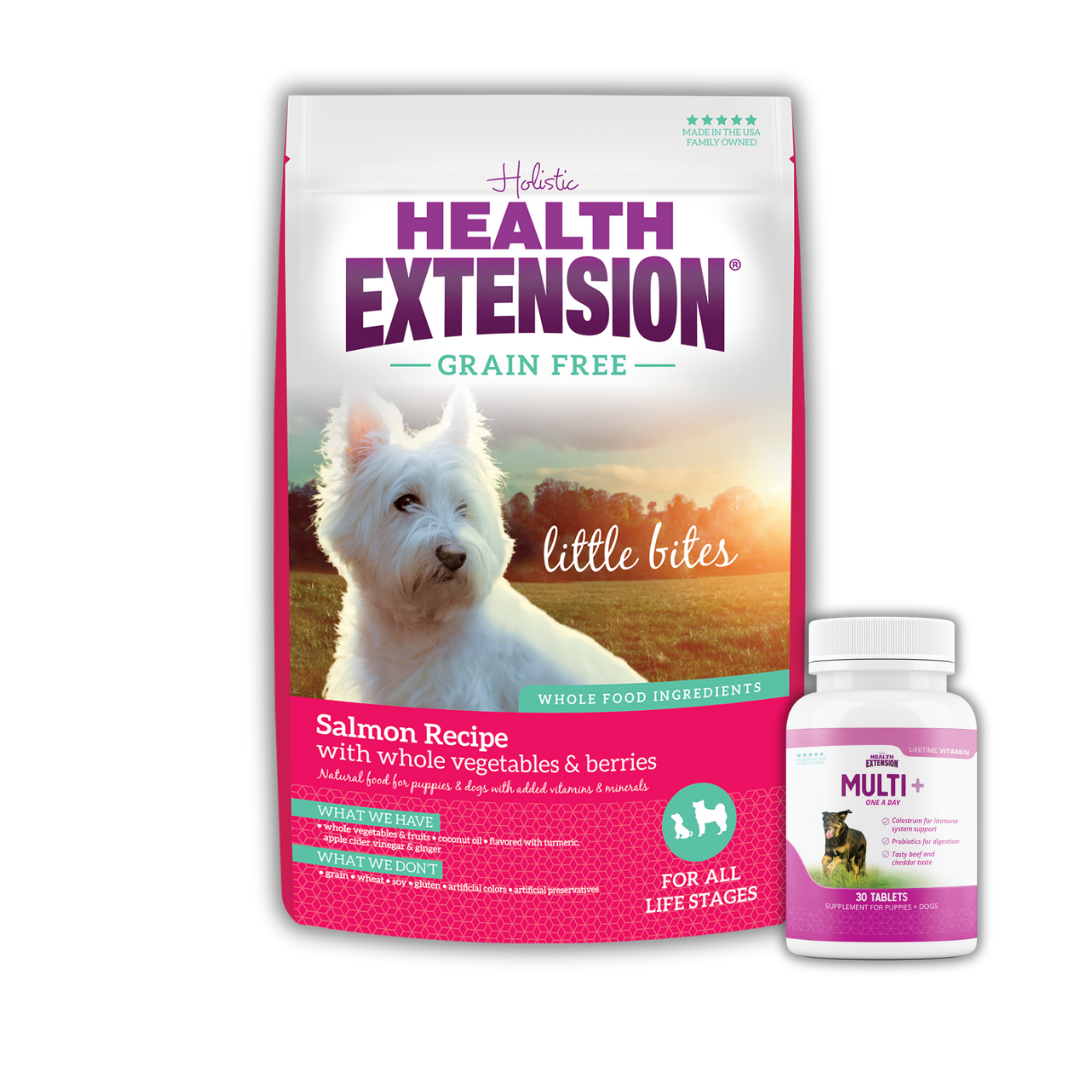 Bag of Health Extension Little Bites Grain-Free Salmon Recipe dog food and a bottle of Multi+ dog vitamins, with an image of a white West Highland Terrier on the package.
