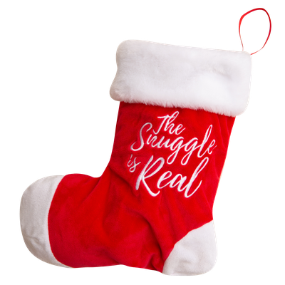 The Snugarooz Hide & Squeak is a red plush stocking dog toy with white trim that says "The Struggle is Real" and hides a fun red spiky ball inside—perfect for festive holiday play with your pup.