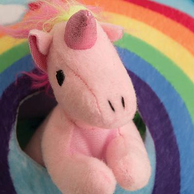 The Snugarooz Hide & Seek Rainbow features three plush unicorn dog toys—purple, pink, and white—hidden in a vibrant rainbow with clouds, creating a fun interactive toy that entertains pups as they discover each unicorn.