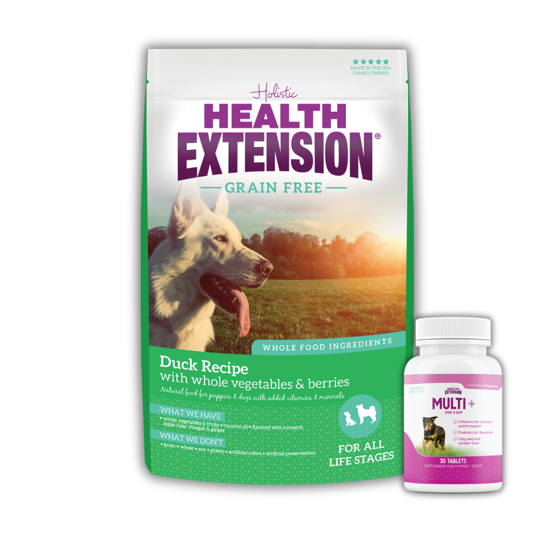 Health Extension Grain-Free Duck Recipe dog food package and a bottle of Multi+ dog vitamins, with an image of a white dog on the bag.