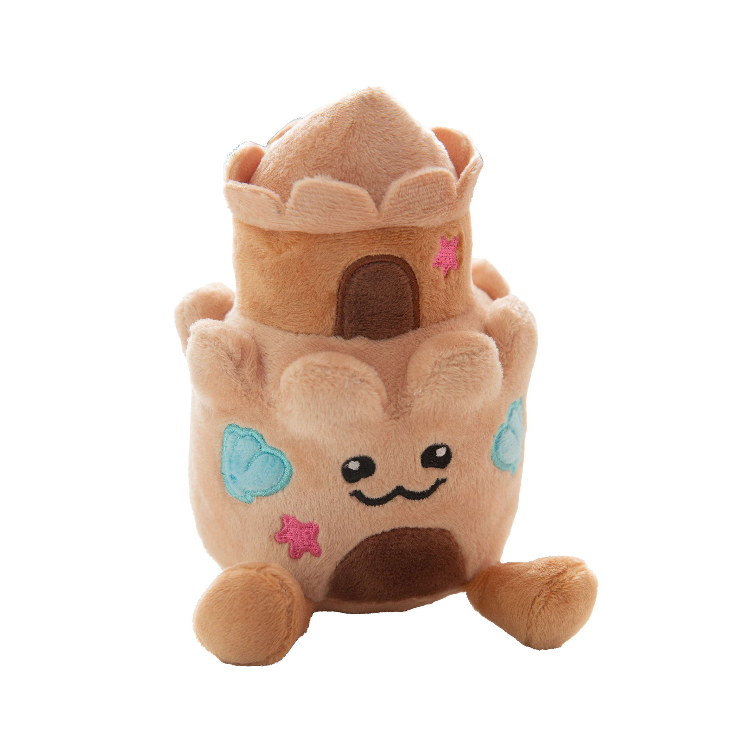 The Snugarooz Snugz Castle is a plush dog toy shaped like a sandcastle, featuring a smiling face, blue shell designs, pink starfish accents, and a brown doorway on a white background.